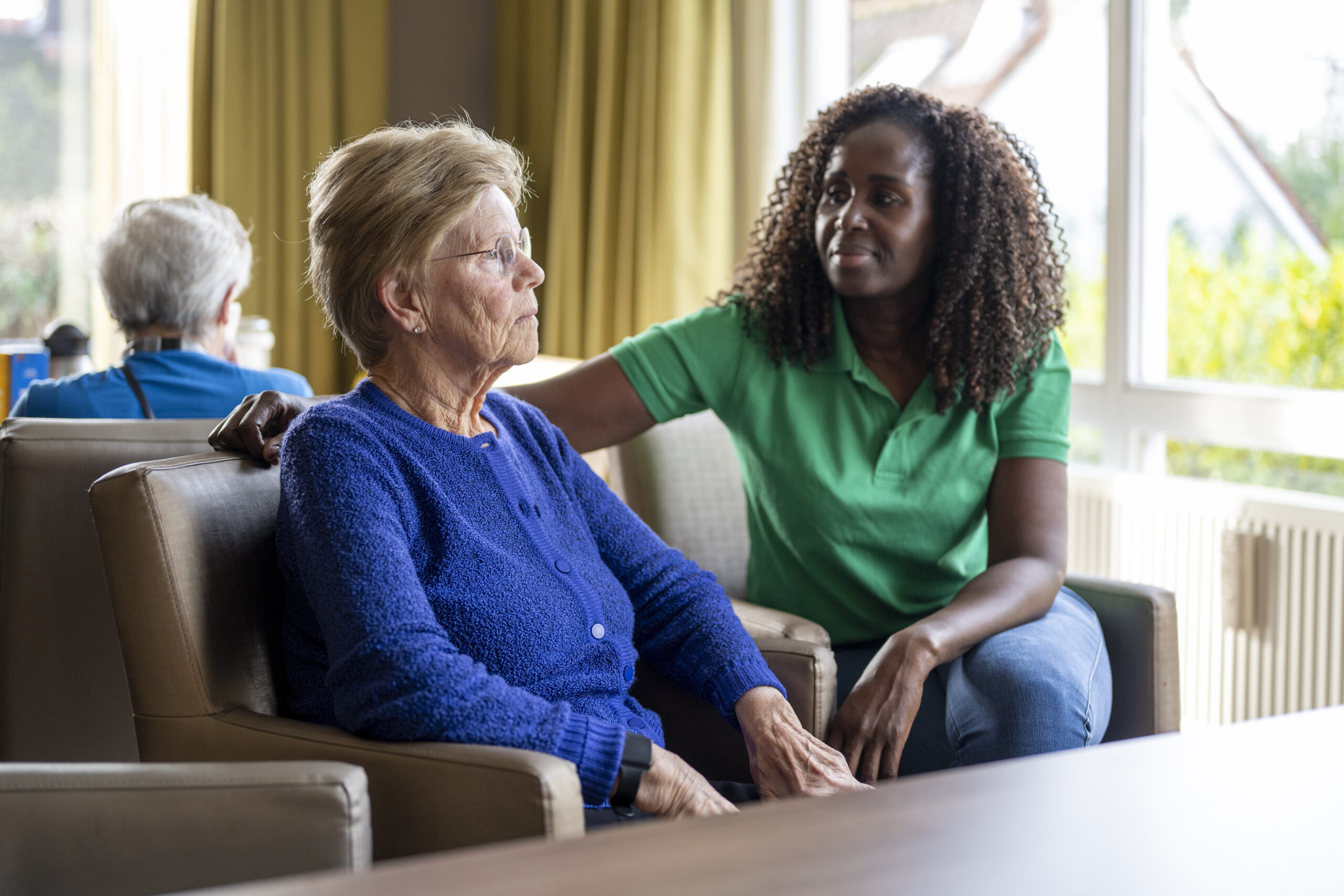 Helper caring for elderly lady